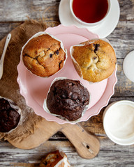 top view of pink cake stand with three muffins