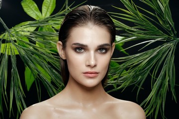 Naklejka premium beautiful woman green leaves nature rest