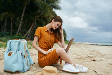 young woman sitting on the beach