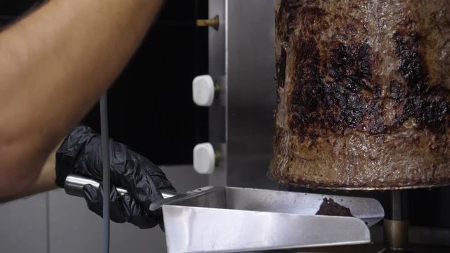 Cooking shawarma and ciabatta meat on a skewer Kebap grill. meat layers strung on a skewer