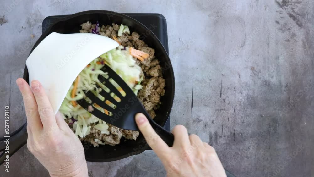 Wall mural adding cabbage to stir fry