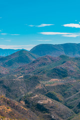 Fototapeta na wymiar Panoramic view of mountains on blue sky