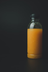 One plastic bottle with orange juice