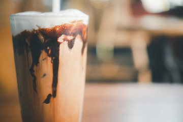 Iced mocha coffee with chocolate cream poured into glass it showing the texture