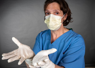 Nurse with scrubs on doning PPE