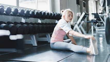 Athletic women exercise at home during coronavirus outbreak. Caucasian girl exercise for arm...
