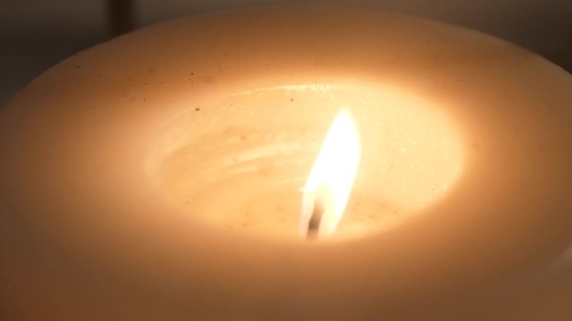 Close-up of burning candle wick over dark wall background, selective focus, Meditation, concentration, wallpaper or background for relax concept
