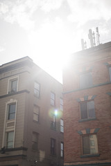 Sun shining through downtown apartment buildings