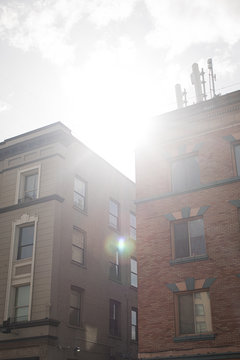 Sun Shining Through Downtown Apartment Buildings