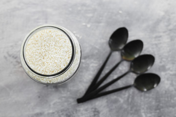 plant-based diet ingredients, kitchen storage jar full of rice shot from top down perspective at...