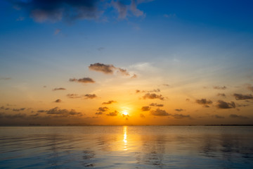 Fototapeta premium Sunset sky with dark clouds above the lake in golden time.