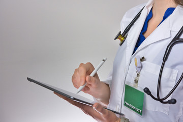Healthcare worker using tablet to conduct healthcare. doctor or nurse practitioner Writing prescription. Physician assistant wearing stethoscope