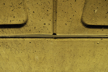 Embossed pattern on a hardended concrete wall with yellow lighting