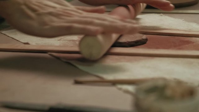Ceramist work in the workshop.