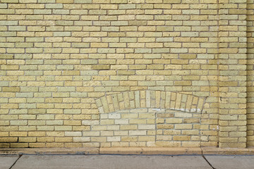 Shabby chic old yellow brick wall texture background with natural weathered appearance, showing a...