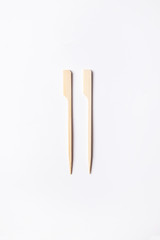 Convenient disposable wooden skewers for food and canapes on a white background