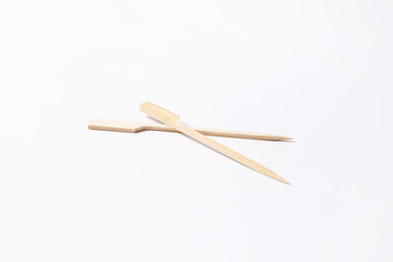 Convenient disposable wooden skewers for food and canapes on a white background