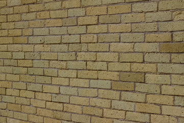 Shabby chic old yellow brick wall texture background with natural weathered appearance