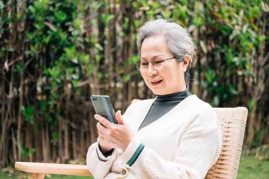 Asian aged woman using a smartphone
