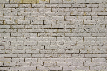 Shabby chic old yellow brick wall texture background, painted white, with natural weathered appearance from aging