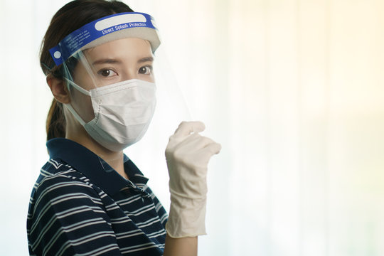 Woman Wearing Protection Medical Screen Or Plastic Shield On Her Face, For Corona Virus Or Covid-19 Protection.