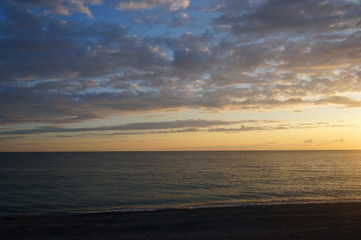 Naklejka na ściany i meble Landscape with sunset on the sea coast