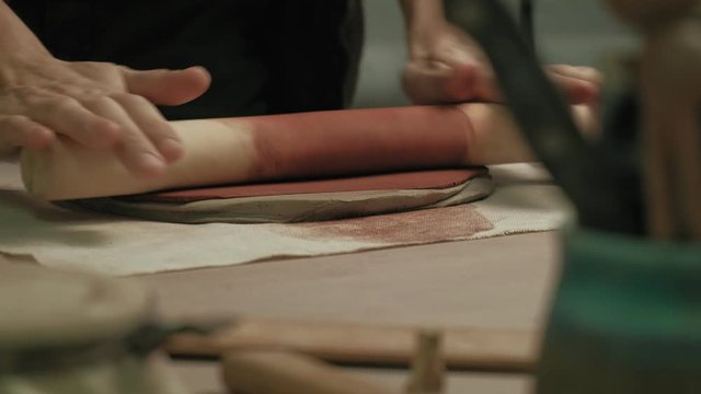 Ceramist work in the workshop.