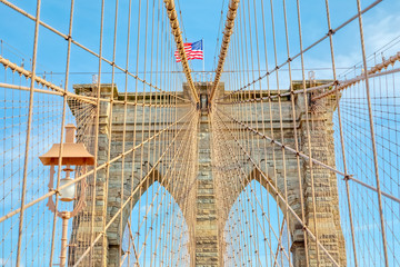 The United States flag on center of Brooklyn Bridge in New York