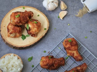 Fried chicken's wings in wooden plate on cement background