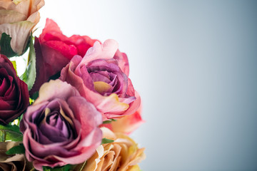 Artificial antique roses on white background.

