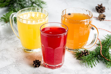 Three different fruit drinks from berries in large glass mugs