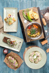 Several dishes in the frame of ear, dumplings, snacks and sandwiches