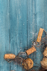 Wooden blue background with fishing net and kara floats