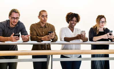 Group of diverse people using smartphones