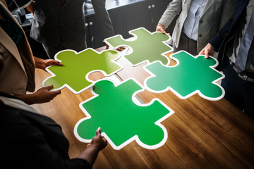 Business people connecting puzzle pieces