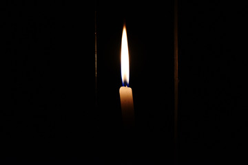 burning candle on black background during lockdown