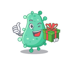 Smiling agrobacterium tumefaciens cartoon character having a green gift box