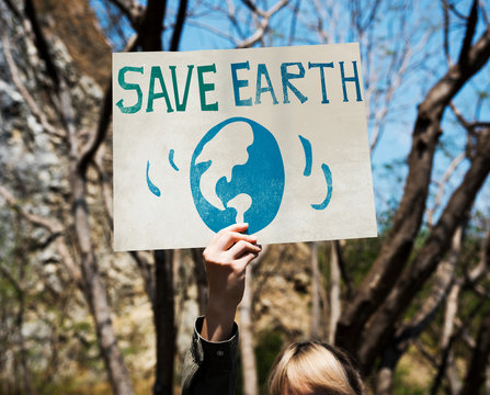 Woman Holding Save The Earth Placard