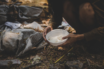 poor people or beggar begging you for help sitting at dirty slum.concept for poverty or hunger...