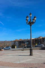 Beautiful street lamp in the spanish city under bright blue sky