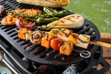 Close up of vegetables on grill over hot coals
