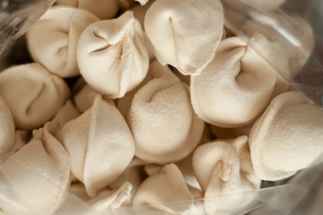 Frozen dumplings close-up in a transparent package.