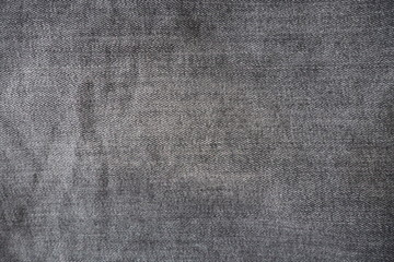 Fototapeta na wymiar Closeup of black jeans fabric with texture and rough surface in black and white or gray vintage tone for background and decoration. Textile texture concept and cool banner on page and cover