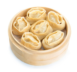 Steamer with oriental dumplings on white background