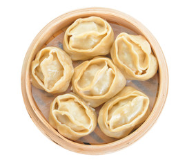 Steamer with oriental dumplings on white background