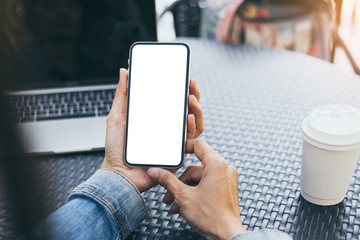 cell phone Mockup image blank white screen.woman hand holding texting using mobile on desk at coffee shop.background empty space for advertise text.people contact marketing business,technology