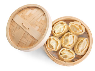 Steamer with oriental dumplings on white background