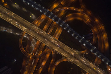 Aerial overhead shot of flyover highway traffic before dawn in Chongqing, China