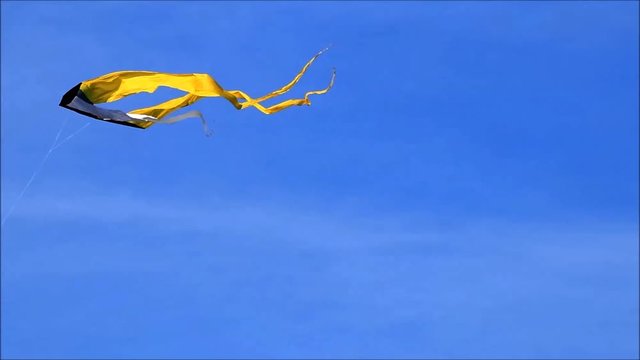 kite is flying in the blue sky
