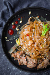 Asian Cuisine, Spicy Asian Beef Noodles on dark background